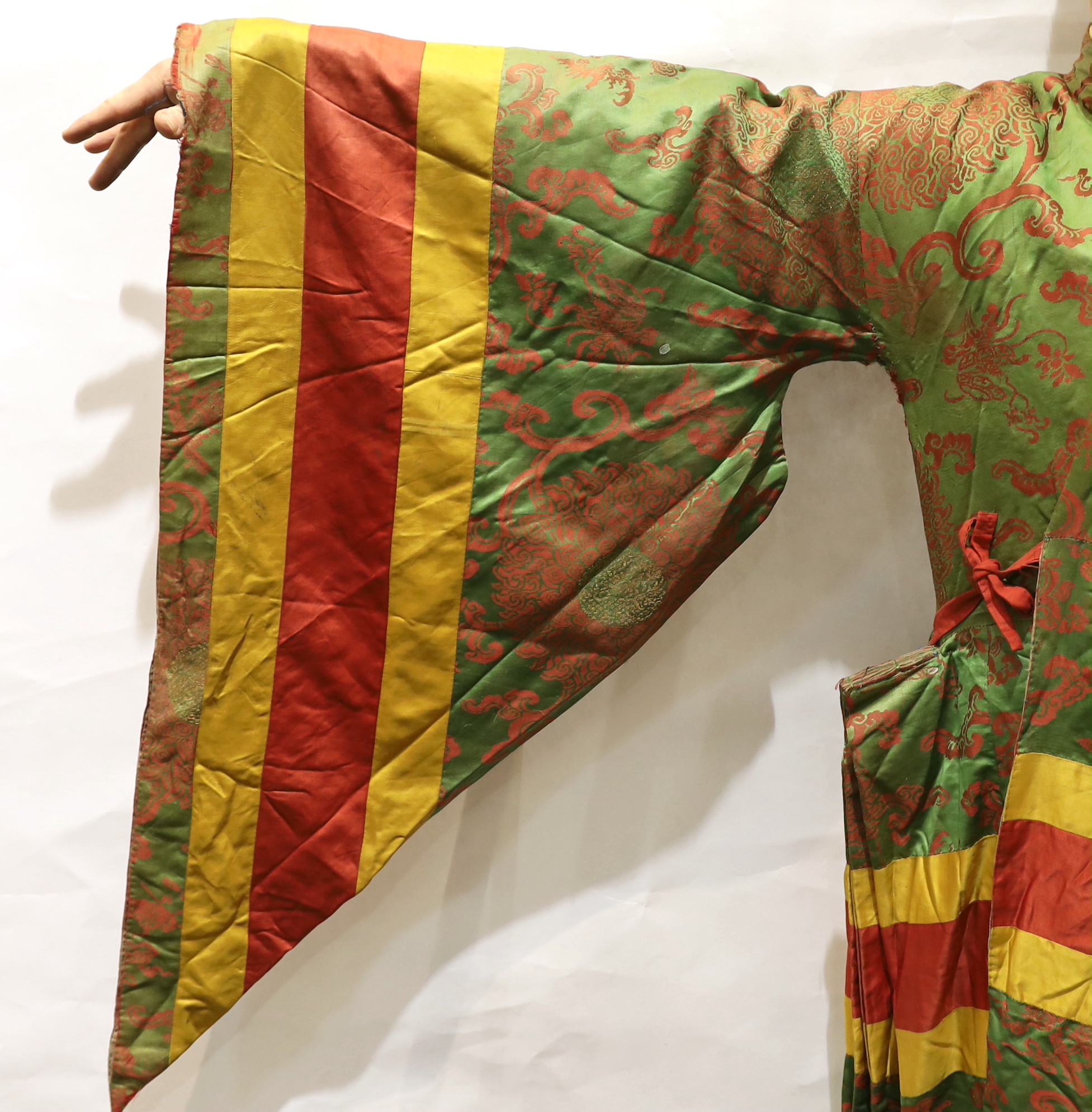 An unusual early 20th century Japanese silk damask kimono, designed with pointed sleeves and wide pleating on the hips, and horizontal yellow and red stripes, possibly a costume for a Kabuki theatre character